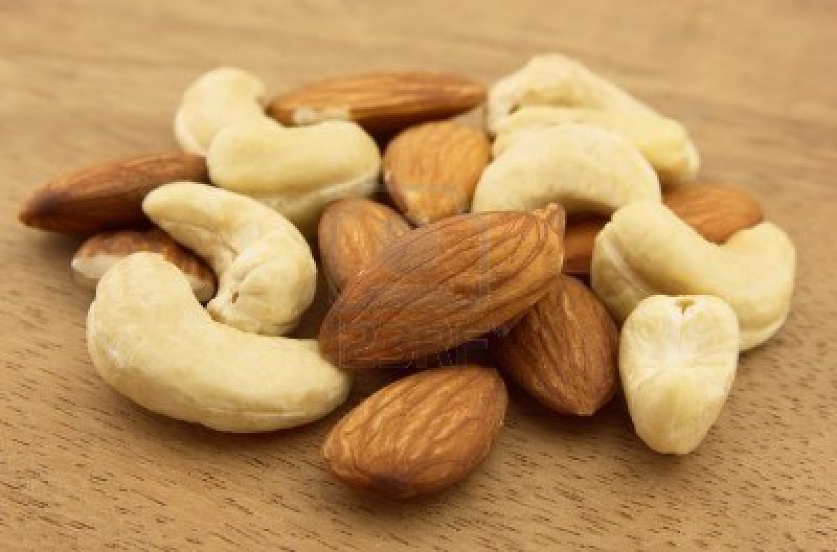 9294321-nuts-of-almonds-and-cashew-on-a-wooden-background.jpg